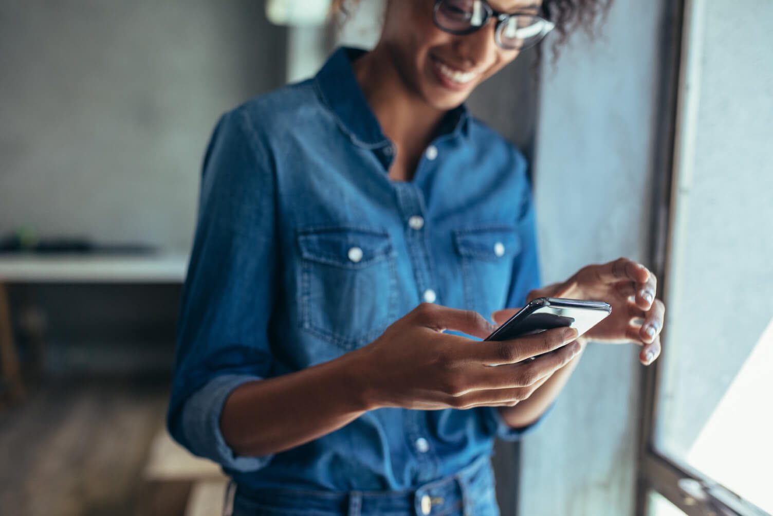 chica sonriendo mirando smartphone